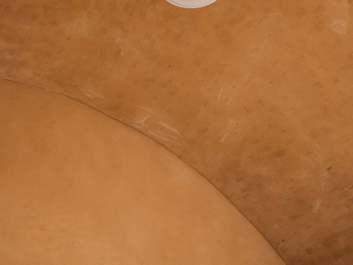 Terracotta lime plaster vault with a ceiling light
