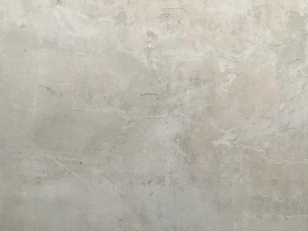 Light grey wall with a mottled mineral texture
