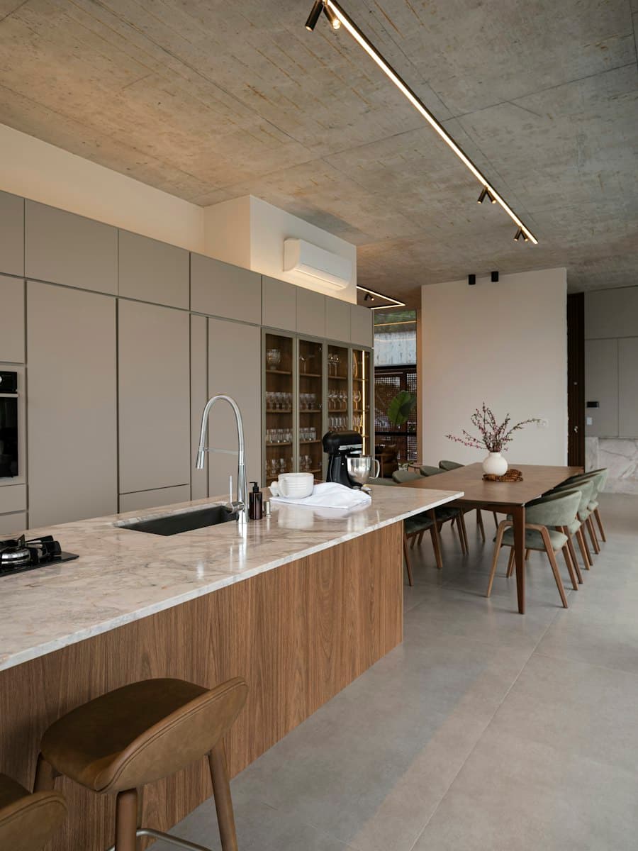 Kitchen with a stone island and concrete ceiling