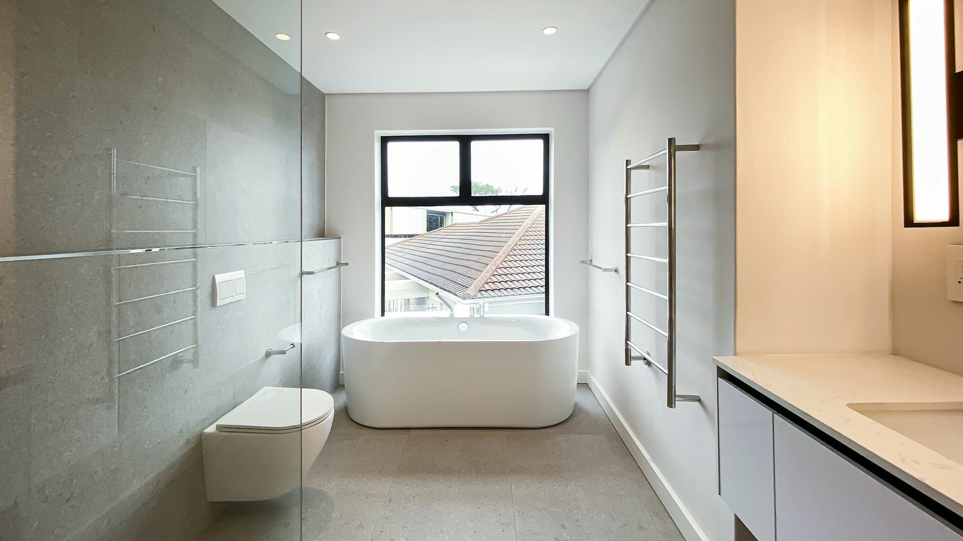 Bathroom with a seamless cement floor and tub